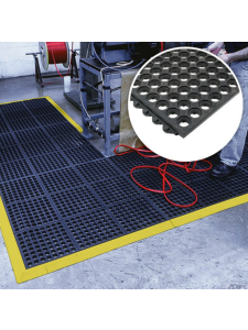 Anti-fatigue rubber floor mat with yellow safety edging in industrial workspace