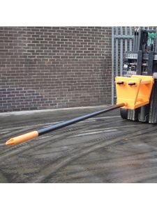 Forklift tine extension attachment in use, extending fork length for handling large or awkward loads safely in industrial environments.