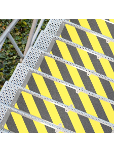 Yellow and black anti-slip stair treads fitted to metal steps for improved safety
