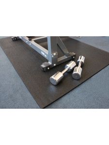 Heavy-duty rubber gym mat under weight bench with dumbbells – protective flooring for gyms, fitness centres, and workout areas.