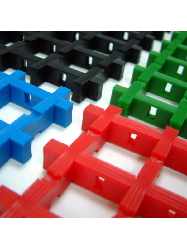 Interlocking plastic floor grating panels available in red, blue, green and black for industrial flooring.