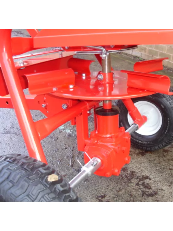 Close-up of fertiliser spreader control mechanism and spreader disc for accurate material distribution.