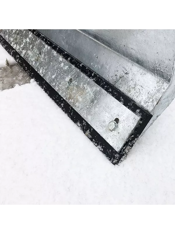 Close-up view of snow plough blade with reinforced rubber edge for surface protection.