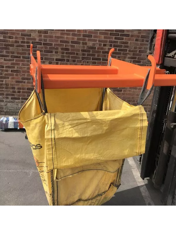 Forklift bulk bag lifter attachment holding a yellow heavy-duty sack for safe material handling in warehouses and construction sites.