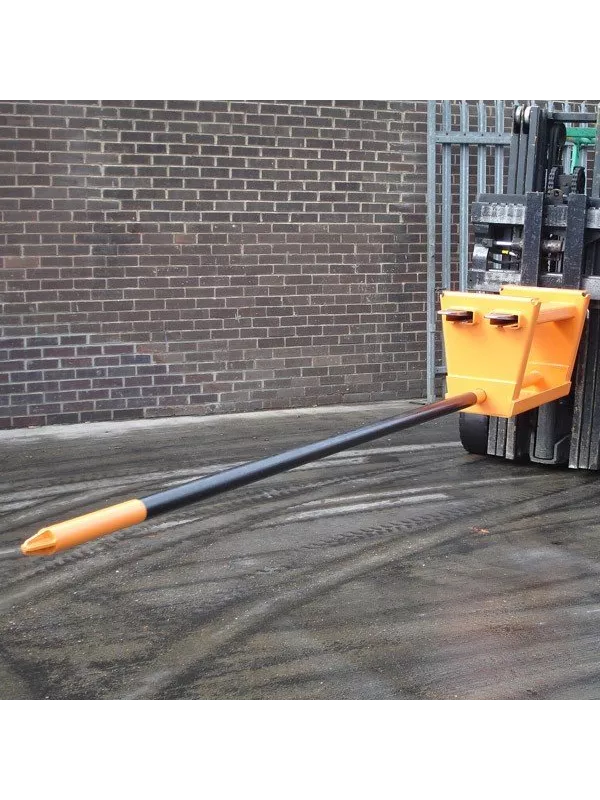 Forklift tine extension attachment in use, extending fork length for handling large or awkward loads safely in industrial environments.