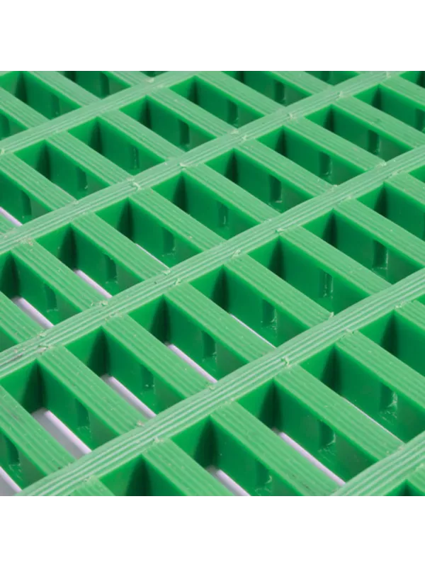 Green heavy-duty modular safety matting with open grid design for drainage and slip resistance.