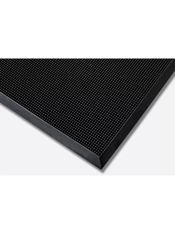 Heavy-duty black entrance mat with textured surface – dirt-trapping and slip-resistant floor mat.