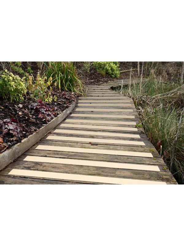 Outdoor wooden steps fitted with anti-slip GRP decking strips – slip-resistant walkway for garden and public paths.