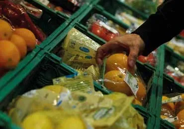 Green stack and nest crates in a supermarket fresh produce display