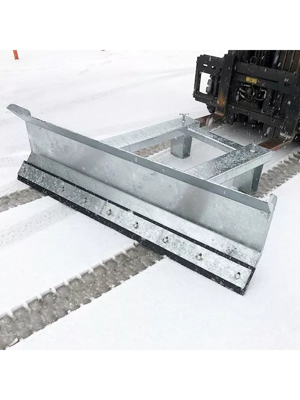 Forklift-mounted snow plough attachment clearing snow from concrete surface.