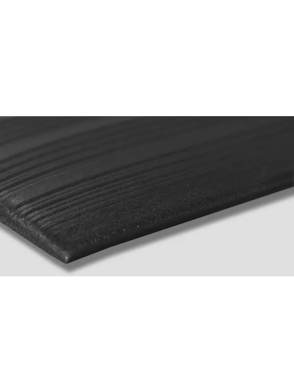 Close-up angled edge of ribbed anti-fatigue mat – durable cushioned matting for industrial use.