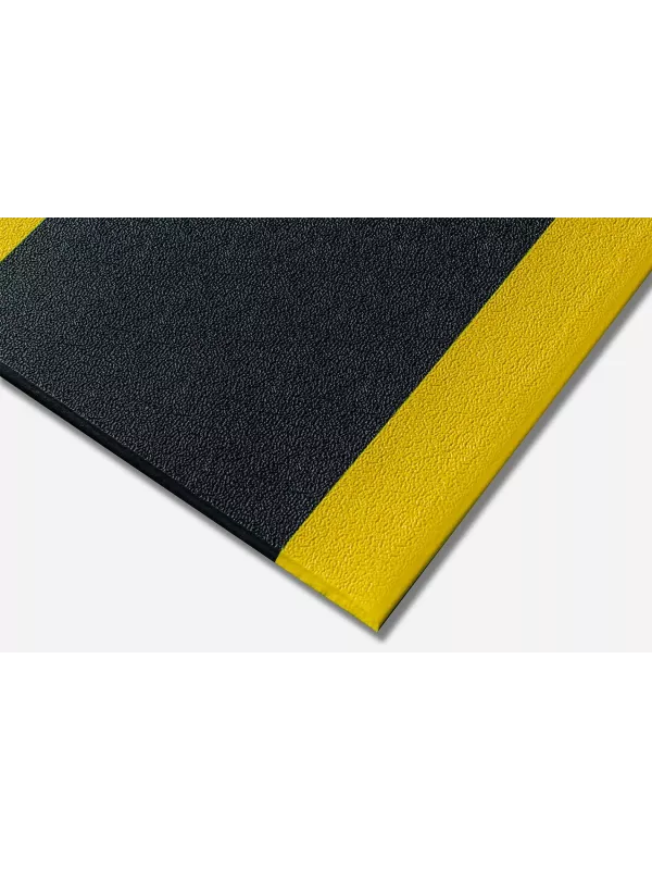 Black anti-fatigue mat with yellow safety border – cushioned slip-resistant floor mat for workplace safety.