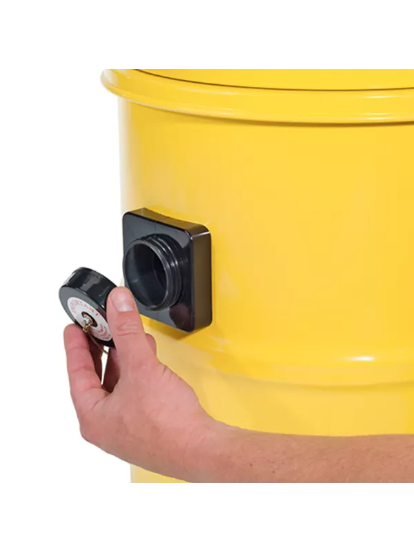 Close-up of a hand adjusting the external power socket on a yellow Numatic vacuum drum.