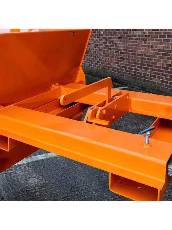 Forklift attachment mechanism on orange tipping skip