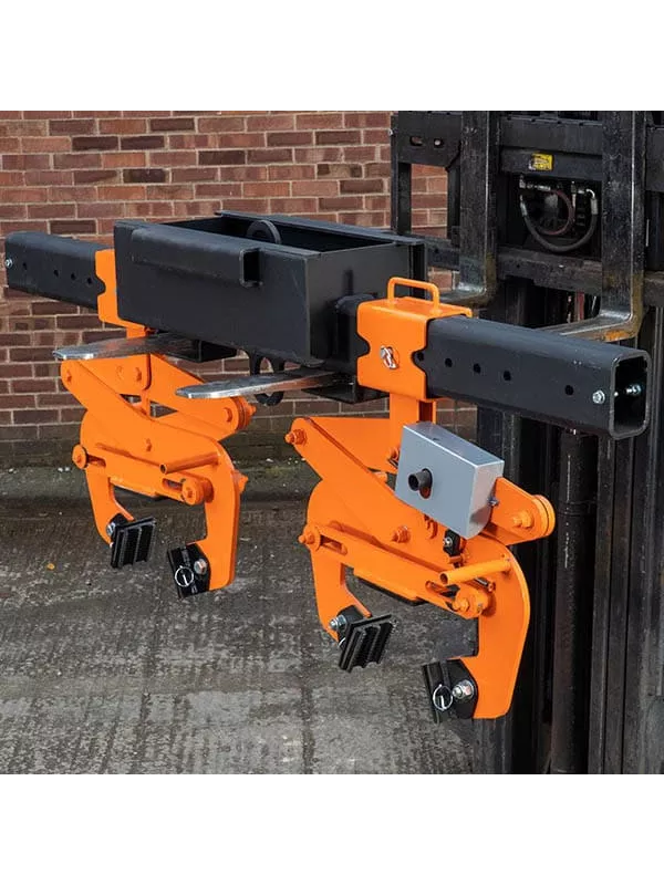 Pair of orange mechanical pipe grab attachments mounted on forklift.