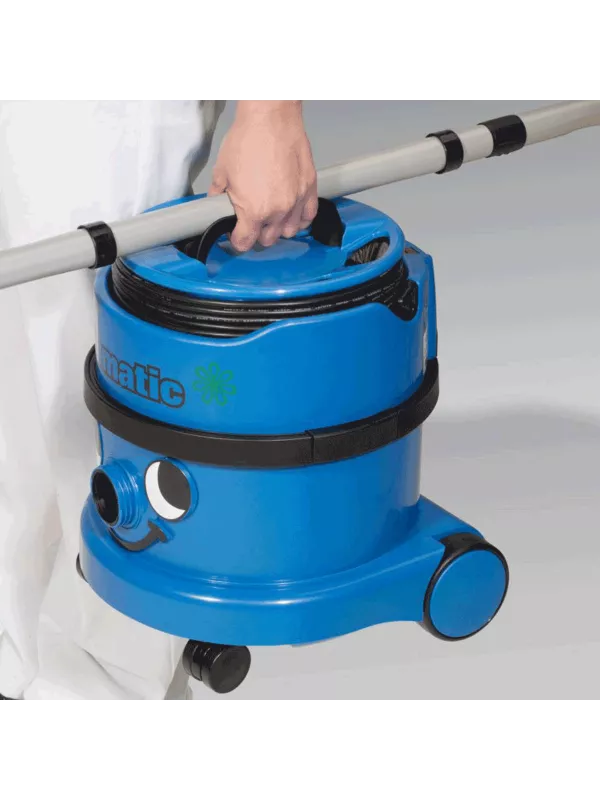 Person pulling a blue Numatic PSP200 vacuum cleaner on wheels.