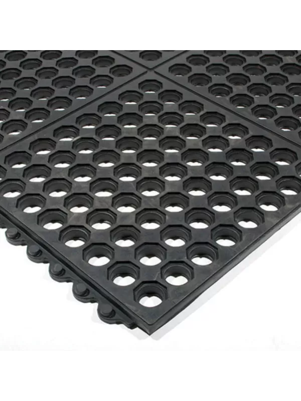 Rubber anti-fatigue mat with perforated anti-slip surface