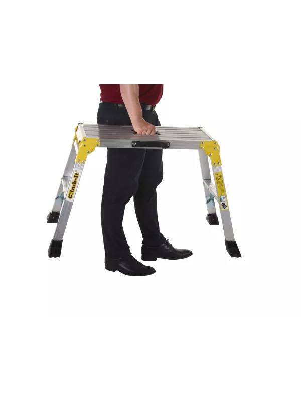 Person unfolding portable aluminium work platform with yellow safety legs.