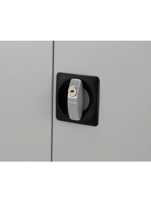 Close-up of lock and key mechanism on steel storage cupboard