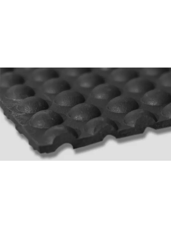 Textured surface of black anti-fatigue mat – cushioned slip-resistant industrial floor matting.