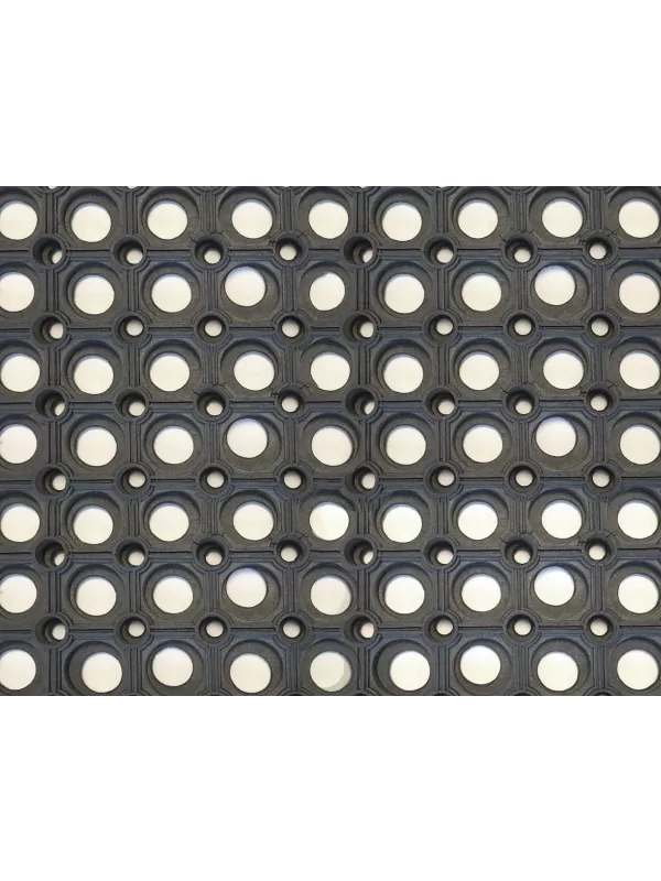 Close-up of rubber ring mat with drainage holes – slip-resistant industrial floor matting.