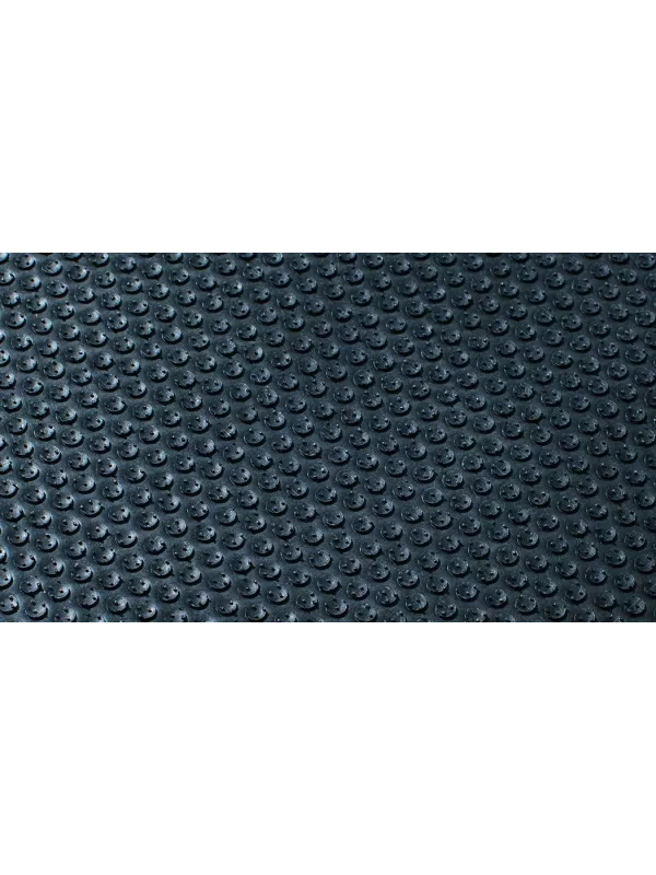 Close-up textured surface of black anti-fatigue mat – durable slip-resistant matting for industrial and commercial use.
