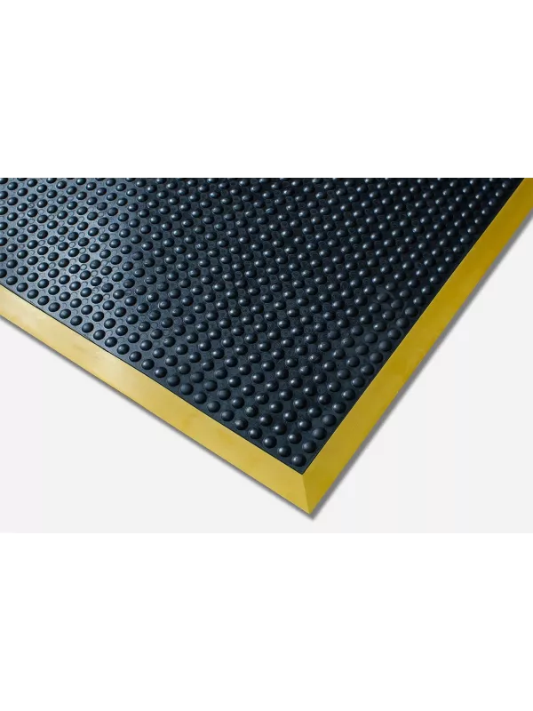Close-up of anti-fatigue safety mat with bevelled yellow edge – durable slip-resistant workplace mat.