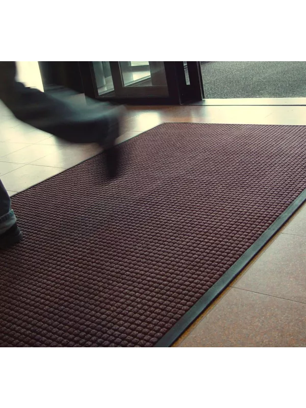 Brown entrance mat in use at doorway – effective dirt-trapping and moisture-absorbing floor mat.