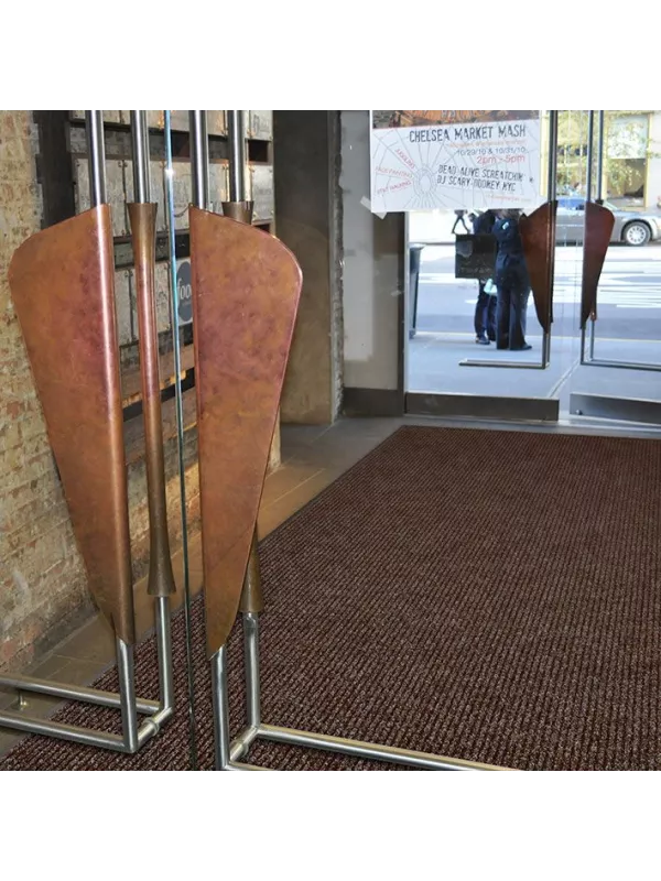 Entrance mat in use at building doorway – effective dirt-trapping floor mat for high traffic areas.