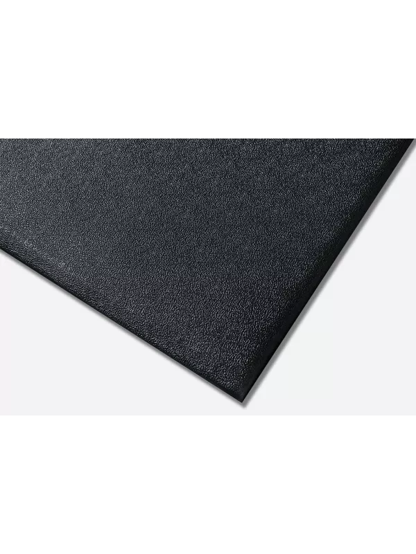 Close-up corner of black anti-fatigue mat – cushioned slip-resistant floor mat for workplace safety.