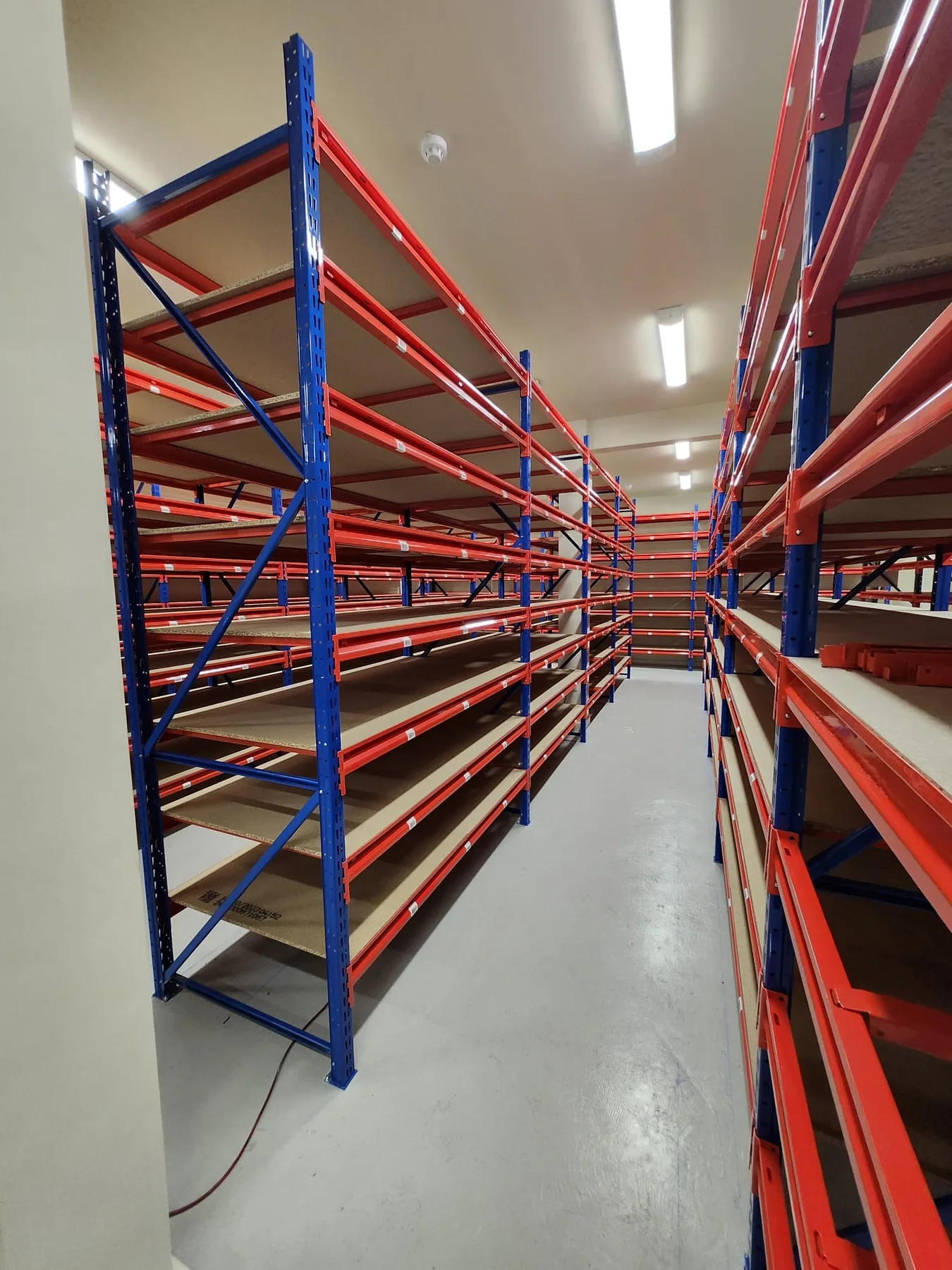 Multi-bay ANCO TS Longspan shelving system with adjustable chipboard shelf levels