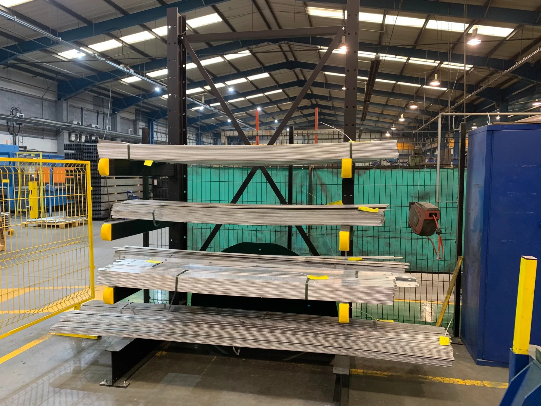 ANCO cantilever racking storing long metal strips and sections in a manufacturing facility