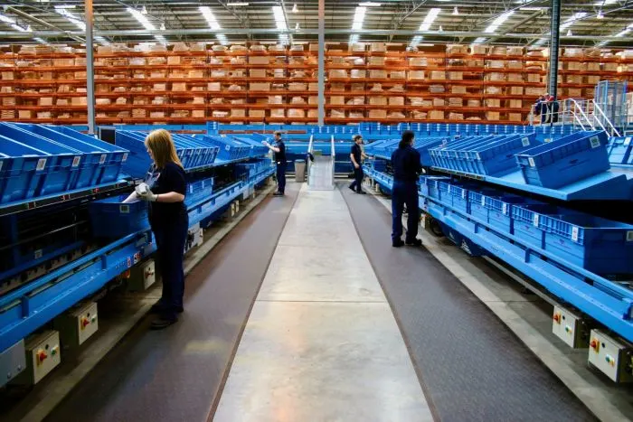 Exceptional Anti-Fatigue Matting for the Workplace Worker standing on heavy-duty anti-fatigue matting at an industrial workstation