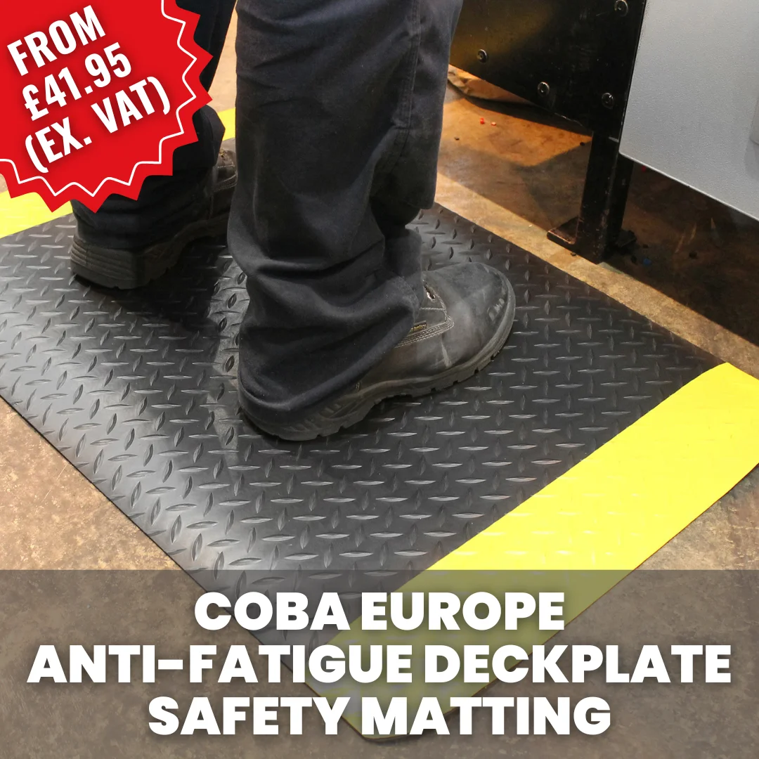Worker standing on a COBA anti-fatigue deckplate safety mat in an industrial workspace, designed to reduce standing fatigue and improve comfort.