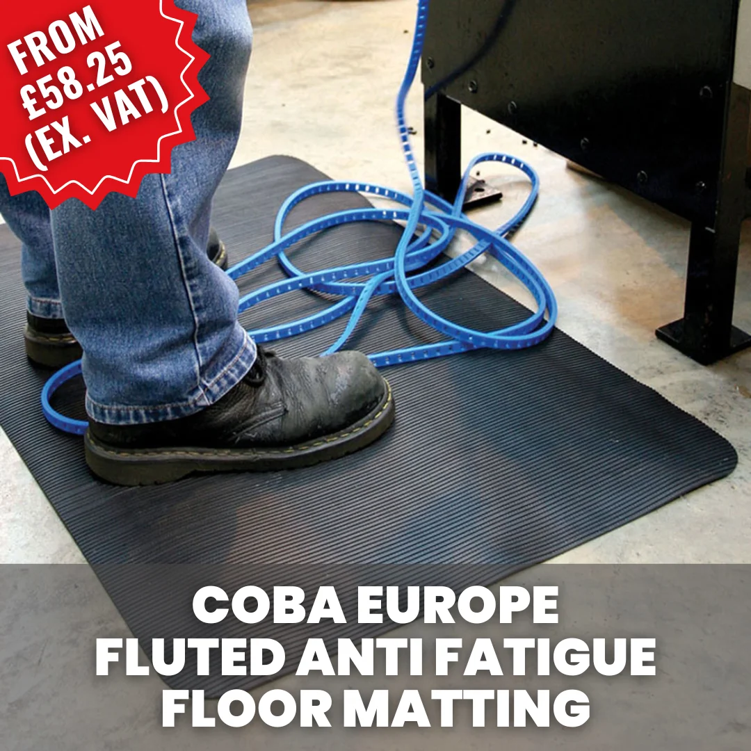 Worker standing on a COBA fluted anti-fatigue floor mat at an industrial workstation, designed to improve comfort and reduce fatigue during standing tasks.